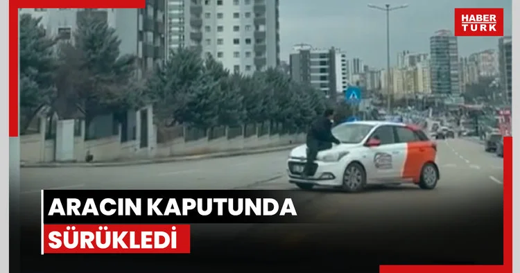 Aracın kaputunda sürükledi