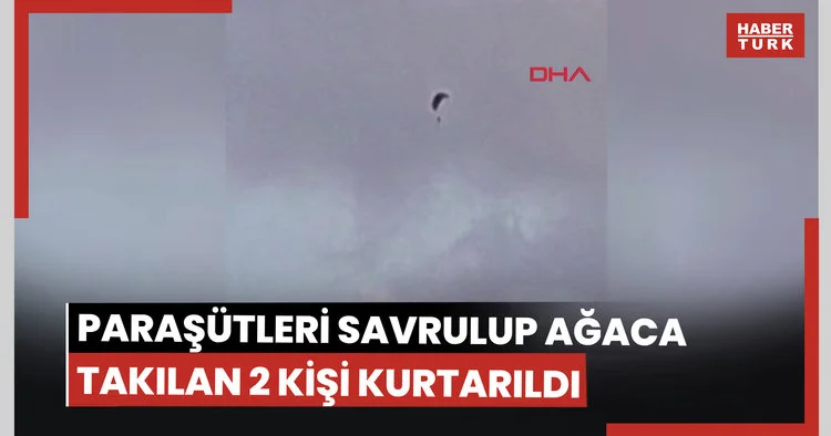 Paraşütleri rüzgarda savrulup zeytin ağacına takılan 2 kişi kurtarıldı; o anlar kamerada