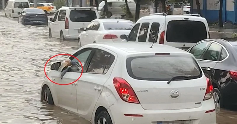 Otomobiline dolan suyu bardakla tahliye etmeye çalıştı